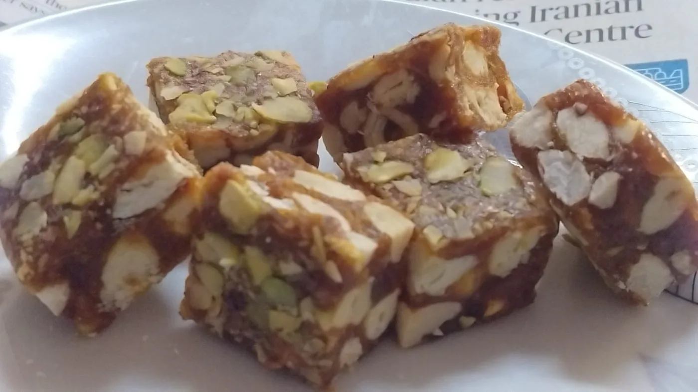 Close-up of date bites showing almonds and pistachios